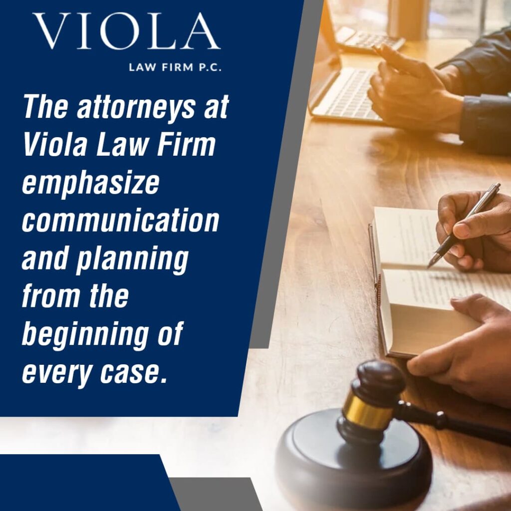 Two people review documents on a desk with a gavel and a book.