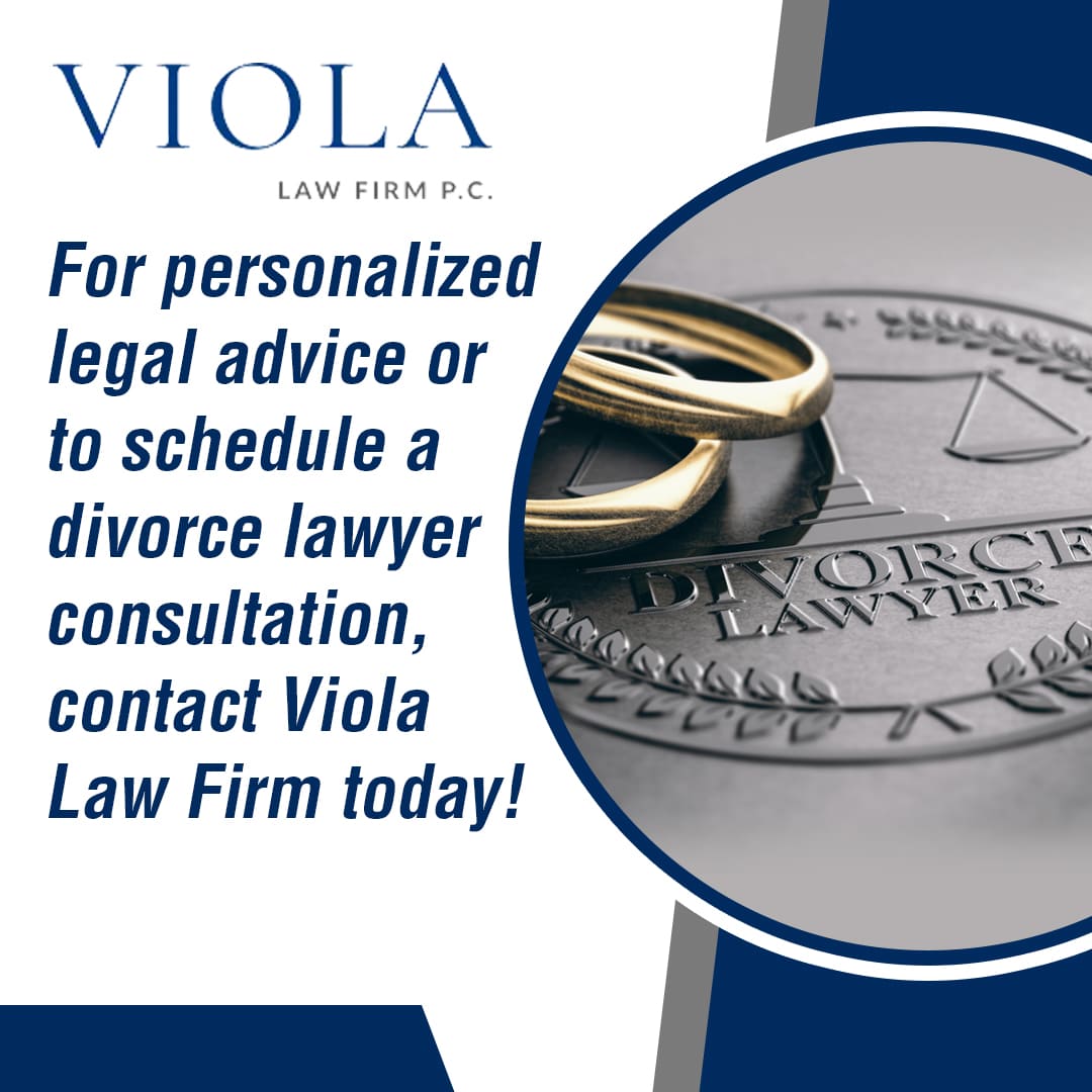 Close-up of two wedding rings on a silver emblem that says 'DIVORCE LAWYER'.